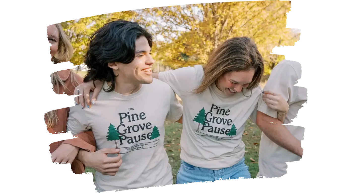 Apparel production team smiling together outdoors in matching printed T-shirts